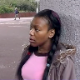 A black girl takes a piss in a public location in the city.